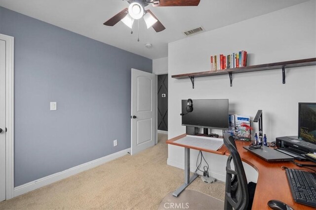 carpeted office featuring ceiling fan