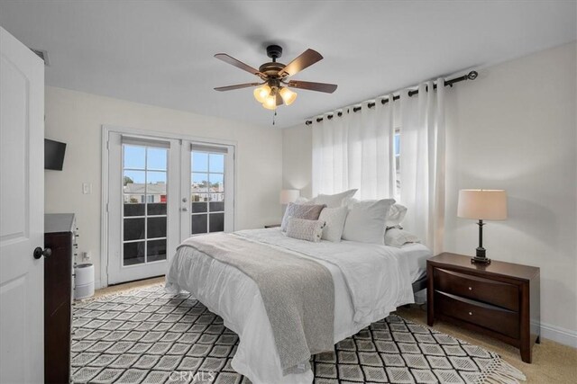 carpeted bedroom featuring access to exterior, french doors, and ceiling fan