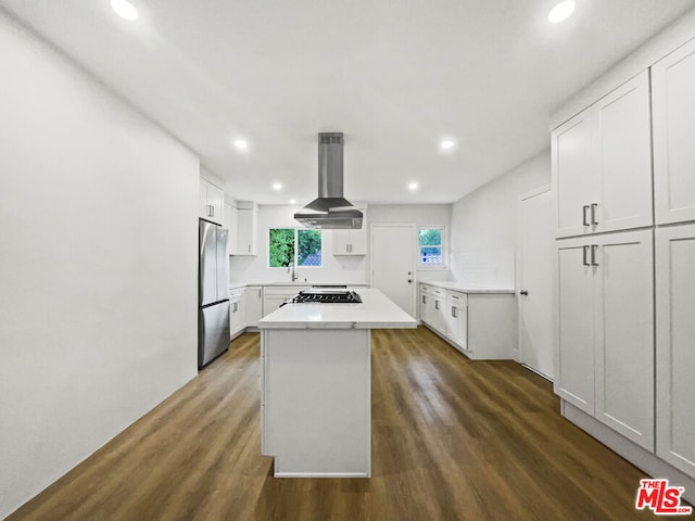 kitchen featuring white cabinetry, extractor fan, stainless steel refrigerator, and dark wood-type flooring