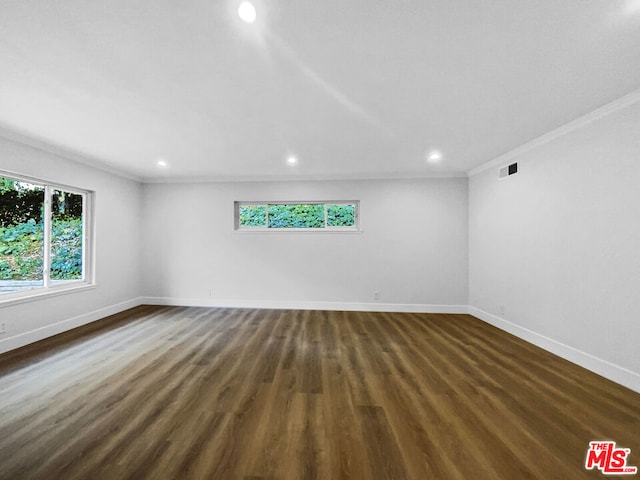 unfurnished room featuring crown molding and dark hardwood / wood-style flooring