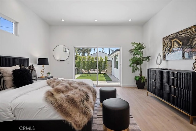 bedroom featuring access to exterior and light hardwood / wood-style flooring