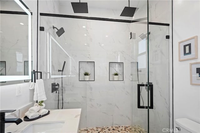 bathroom featuring toilet and walk in shower