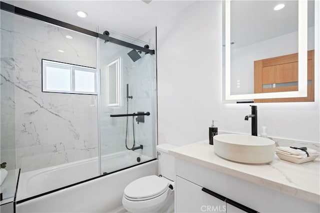 full bathroom featuring vanity, toilet, and enclosed tub / shower combo