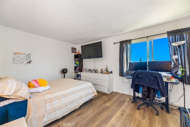 bedroom with hardwood / wood-style floors