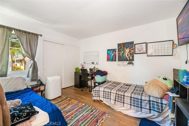 bedroom featuring hardwood / wood-style flooring and a closet