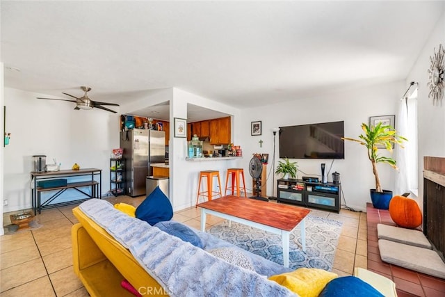 living room with ceiling fan and light tile patterned flooring