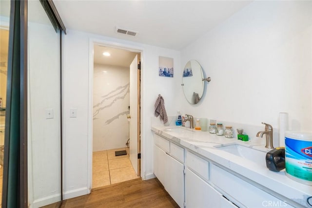 bathroom with vanity and hardwood / wood-style flooring