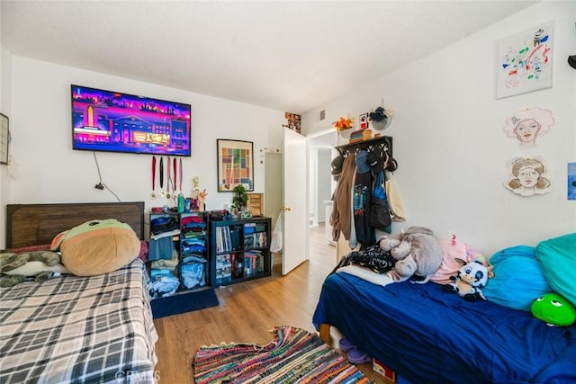 bedroom with light hardwood / wood-style floors