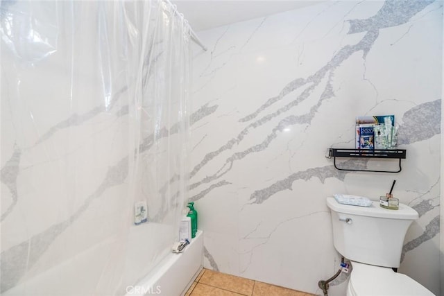 bathroom featuring tile patterned floors, toilet, and shower / bath combo with shower curtain