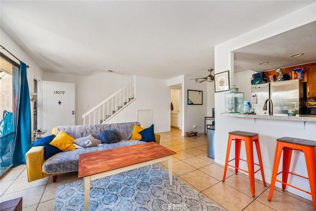 tiled living room featuring ceiling fan