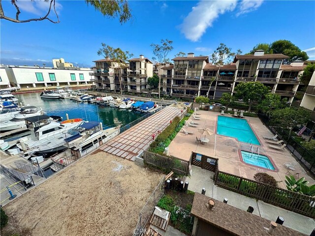 view of pool featuring a patio and a water view