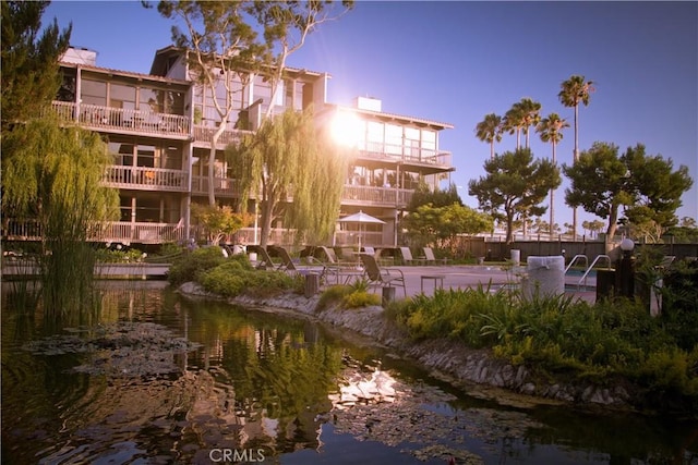 outdoor building at dusk featuring a water view