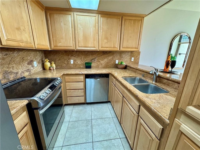 kitchen with sink, stainless steel appliances, tasteful backsplash, light tile patterned flooring, and light brown cabinetry