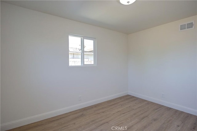 unfurnished room with light wood-type flooring