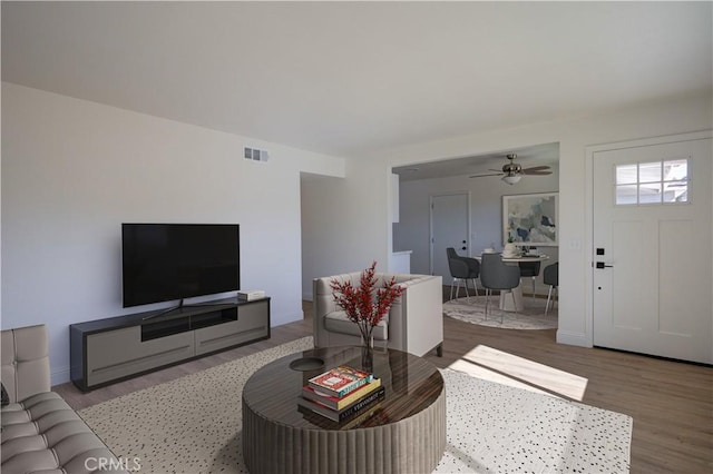 living room featuring light hardwood / wood-style flooring and ceiling fan