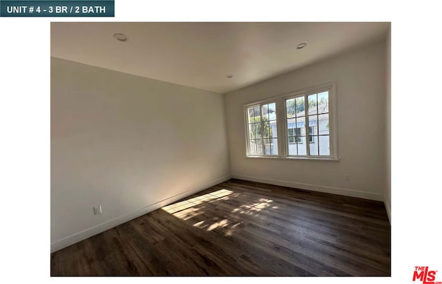 empty room featuring dark hardwood / wood-style flooring