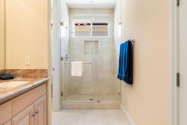 bathroom with tile patterned floors, vanity, and a shower with shower door