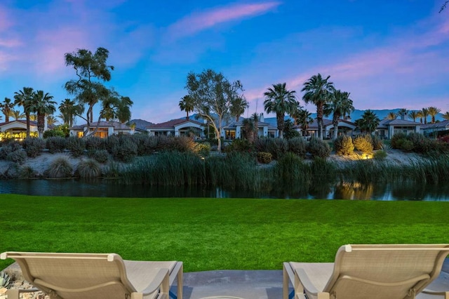 yard at dusk with a water view