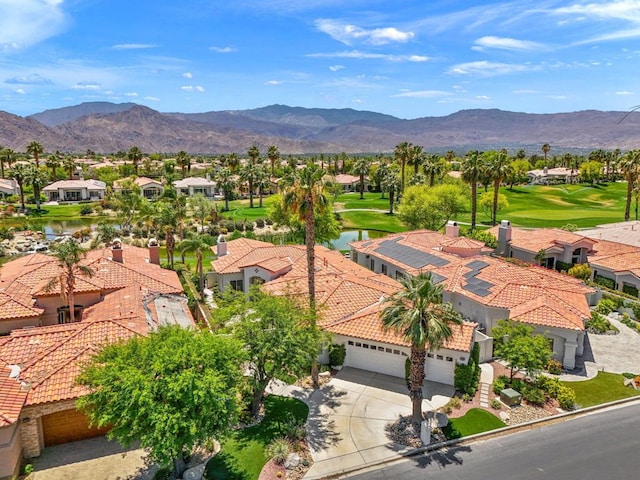 birds eye view of property with a water and mountain view