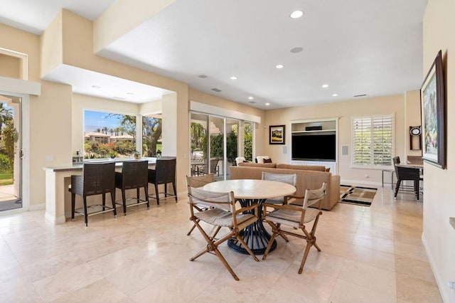 tiled dining space with a healthy amount of sunlight