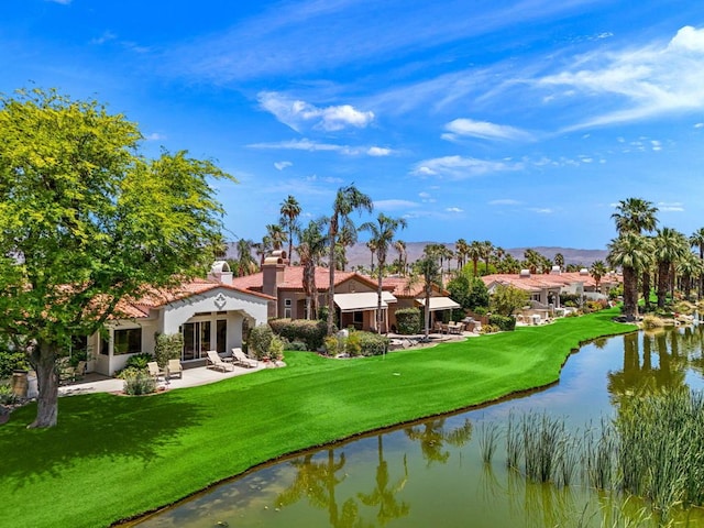 exterior space featuring a water view, a yard, and a patio