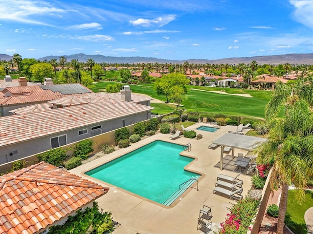 view of swimming pool featuring a mountain view and a patio