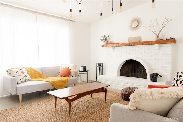 living room with concrete floors and a brick fireplace