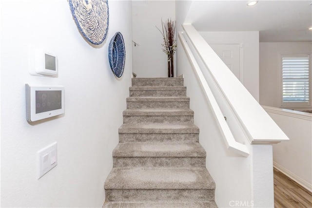 stairs with hardwood / wood-style floors