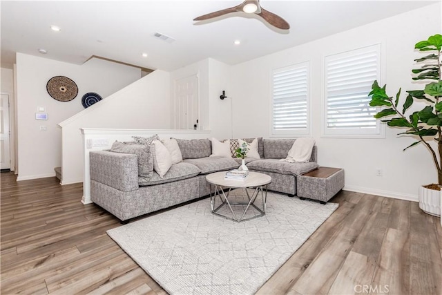 living room featuring ceiling fan and hardwood / wood-style flooring