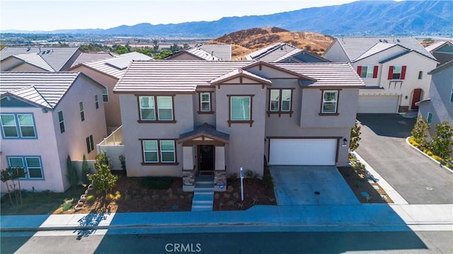 view of front of property featuring a mountain view and a garage