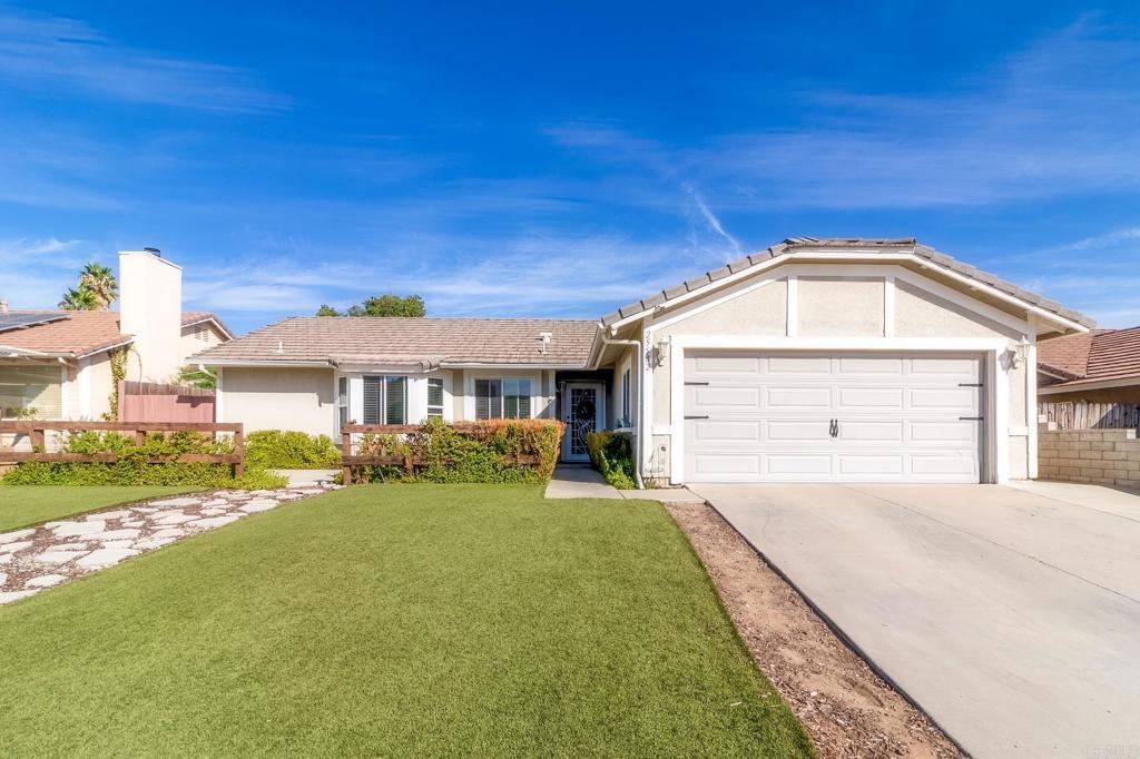 ranch-style house featuring a front yard and a garage