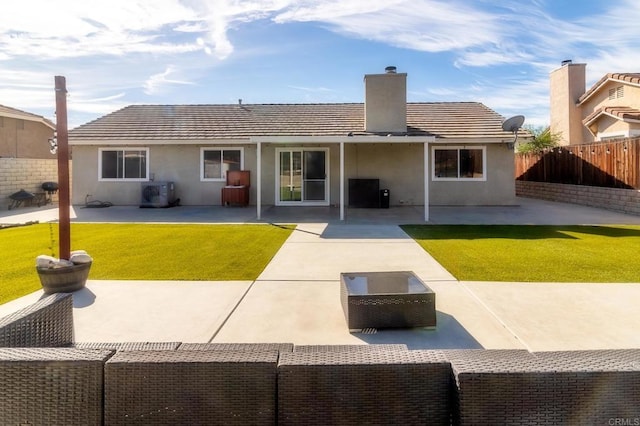 rear view of property featuring a yard and a patio