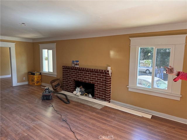 living room with hardwood / wood-style floors and a brick fireplace