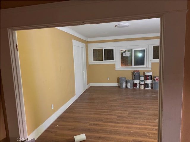 hall with ornamental molding and dark hardwood / wood-style floors