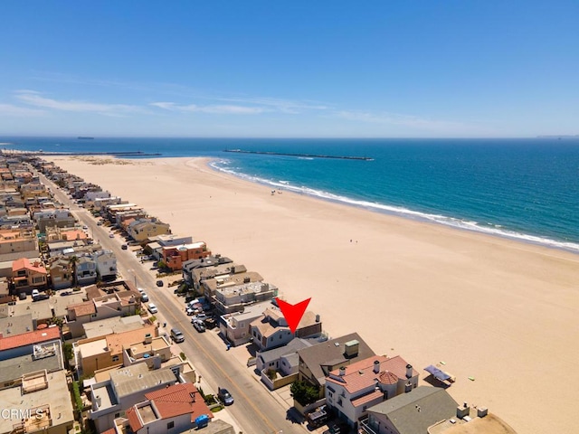 drone / aerial view with a beach view and a water view