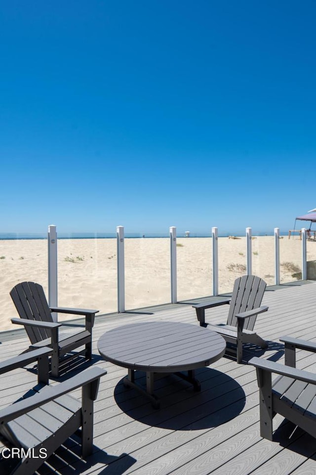 wooden terrace with a view of the beach