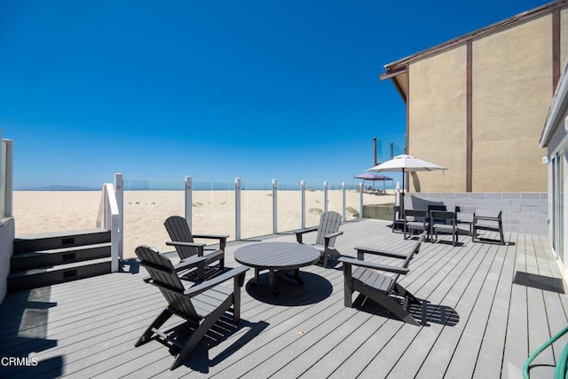 wooden terrace with outdoor dining space