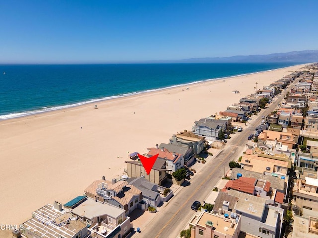 birds eye view of property featuring a beach view and a water view