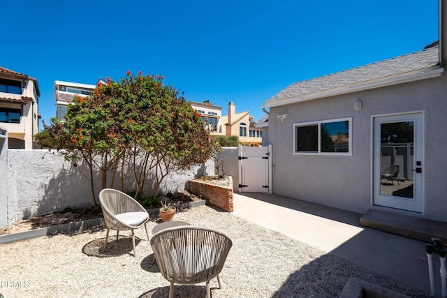 view of patio / terrace featuring fence and a gate