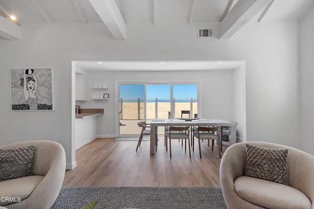 dining area with beam ceiling, visible vents, baseboards, and wood finished floors