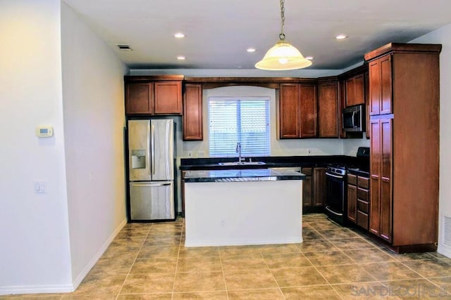 kitchen featuring sink, hanging light fixtures, light tile patterned floors, a kitchen island, and appliances with stainless steel finishes