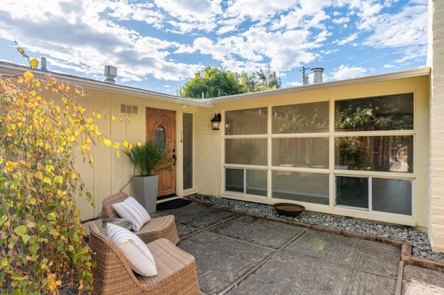 doorway to property with a patio area