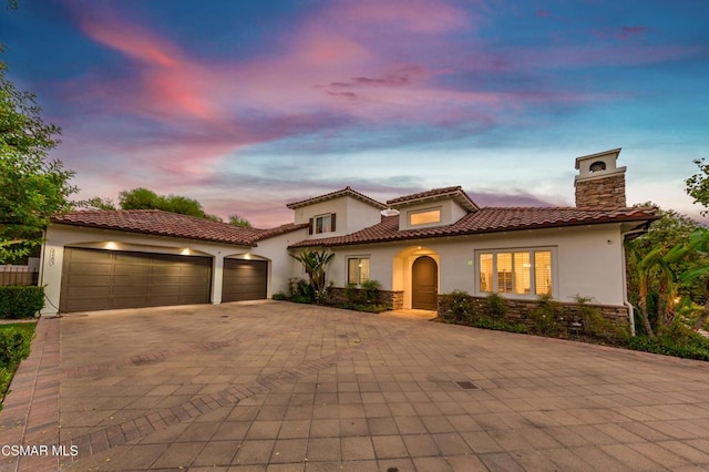 mediterranean / spanish house featuring a garage