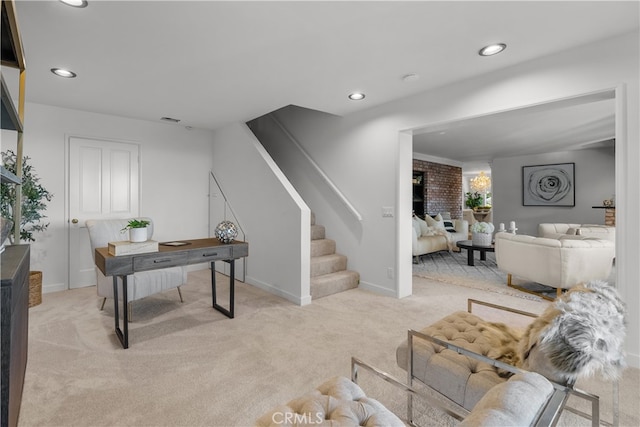 office area with a fireplace and light colored carpet