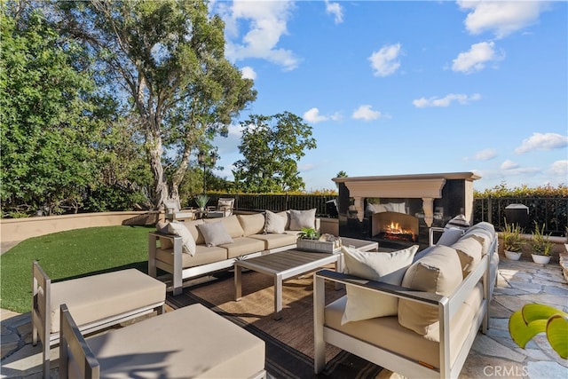 view of patio featuring an outdoor living space with a fireplace