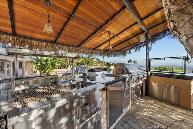 view of patio featuring area for grilling, a gazebo, and exterior kitchen