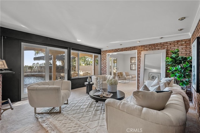 carpeted living room with brick wall and ornamental molding