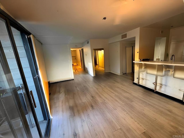 unfurnished living room with light wood-style flooring and visible vents