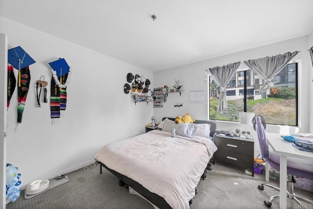 carpeted bedroom featuring baseboards