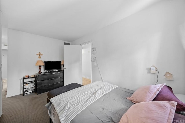 carpeted bedroom featuring visible vents and baseboards